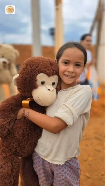 Menina abraça um urso de pelúcia